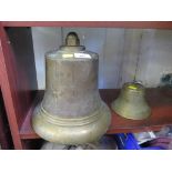 Two brass alloy bells, 25cm high and 9cm high