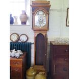 A George III pine longcase clock, the caddy top over a brass dial with gilt metal mask spandrels,