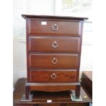 A Stag Minstrel mahogany bedside cabinet with four drawers, 53cm wide and another chest with five