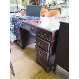 An Edwardian mahogany pedestal desk, the leather inset top over pedestals each with four drawers