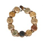 A Victorian bracelet with eleven small lava cameos set in gold colour metal