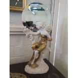 A faux marble Art Nouveau figure of a lady seated on a rock, after Louis Beataux, with circular