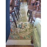 A large European style ivory field carpet, with green foliate scroll and floral medallion and