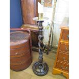 A stained wood open barley twist turned torchere, with brass candle holder 90cm high