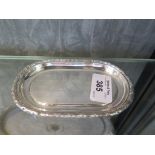 An oval silver pin tray
