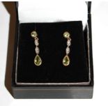 A pair of diamond and peridot earrings