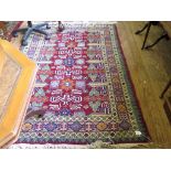 A Persian ivory field prayer rug with palmette and herati border, 172cm x 116cm, and a Kazak rug