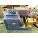 A 19th century tin and brass magic lantern, parts missing, 47cm long, and two boxes of slides,
