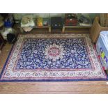 A Kashmir rug, the blue ground with central ivory medallion and all over scroll design within an