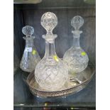 Three glass decanters and a silver plated tray