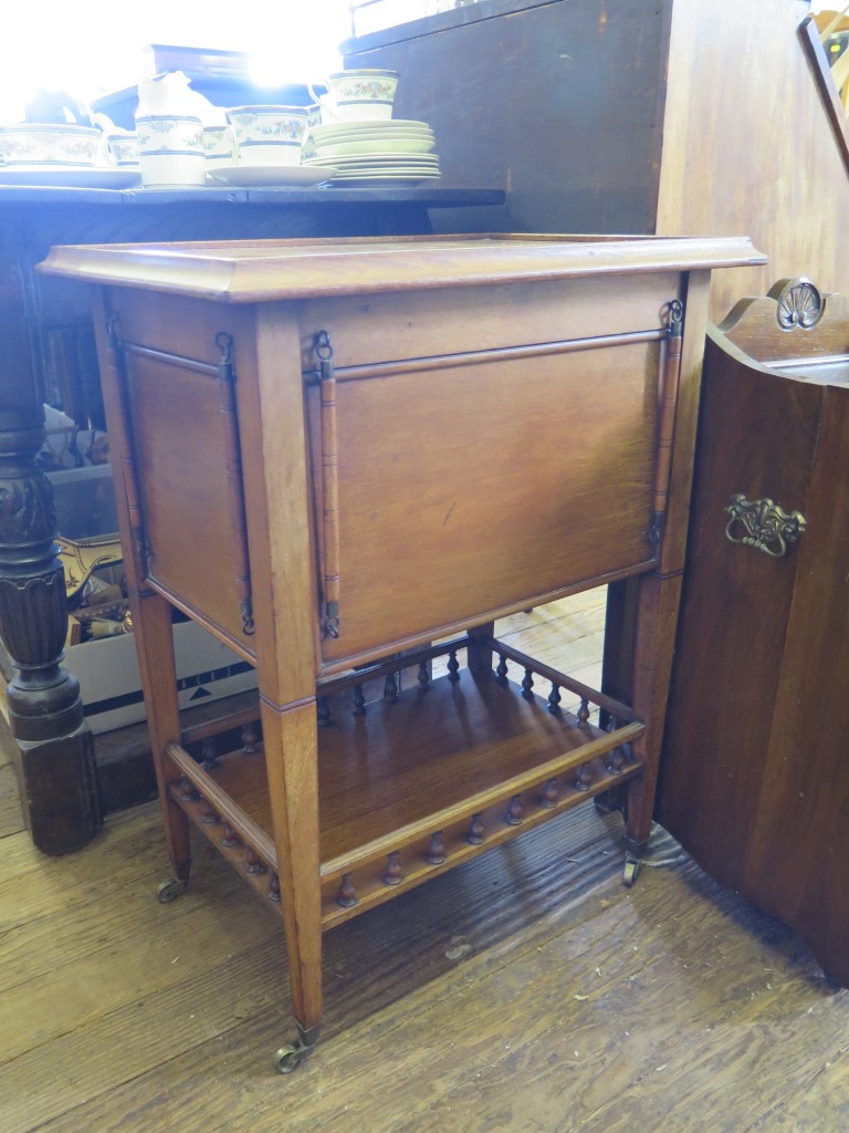 A mahogany tea trolley with drop down sides and spindle gallery to undershelf, 55cm wide