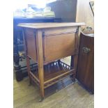 A mahogany tea trolley with drop down sides and spindle gallery to undershelf, 55cm wide