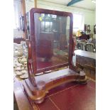 A Victorian mahogany toilet mirror, the rectangular plate in scroll supports on a concave base, 65cm