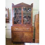 A Regency mahogany and boxwood inlaid secretaire bookcase, with arrow motifs, the anthemion inlay