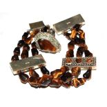 A three row tigers eye bracelet with silver plaques, and matching ring