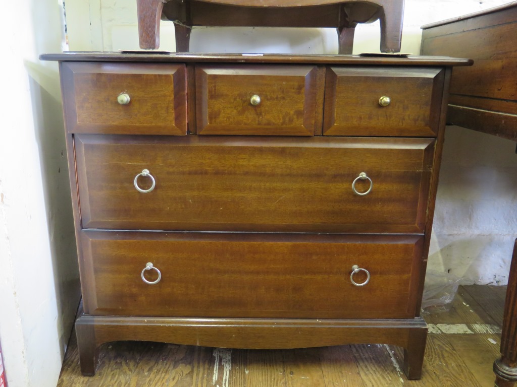 An Edwardian walnut chest with three long graduated drawers on bracket feet, 107cm wide