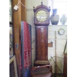 An early 19th century mahogany long case clock, with brass finials, circular painted dial and