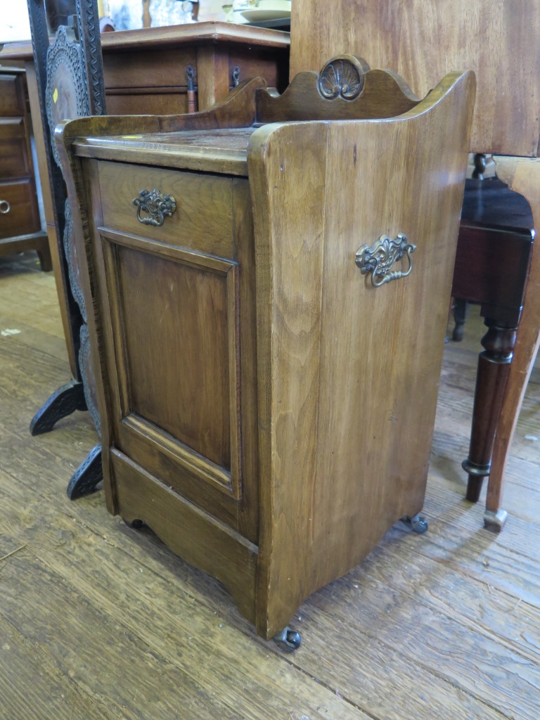 An Edwardian purdonium, with raised back, fall front and pot castors, 35cm wide, and a beech