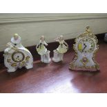 A 1920's French clock garniture set, the arched clock case with grape vine, surmounted by a