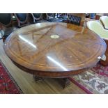 A flame mahogany and boxwood strung Jupes Patent circular dining table, the rotating top to fit