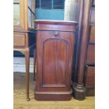 A Victorian mahogany bedside cabinet, the square top over an arch panel cupboard door on a plinth