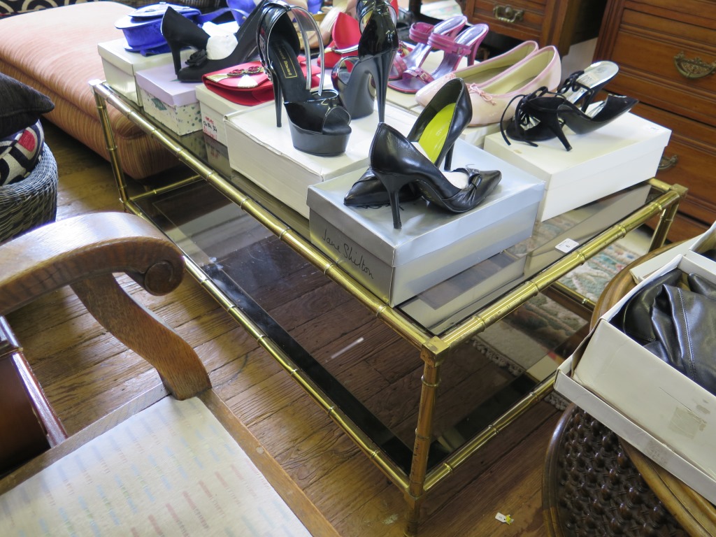 A brass bamboo style coffee table, with two tiers of glass shelves, 115cm x 65cm