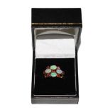 An opal and ruby ring set in 18 carat gold