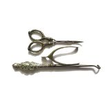 A silver handled button hook and scissors and a silver wish bone pair of sugar tongs