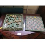 An Aztec style chess set, of malachite type resin 26cm square