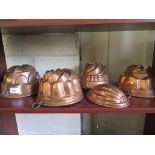 Five late Victorian copper jelly moulds, largest 21cm diameter