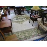 A large European style ivory field carpet, with green foliate scroll and floral medallion and