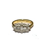 A diamond cluster ring set with round and baguette stones in 18 carat gold