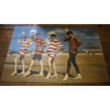 A Reveille Special poster of The Beatles on a beach (pinholes and slight losses to corners) 101cm