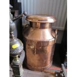 A copper milk churn, South Coast Dairies Ltd, the lid stamped WUDL Trowbridge 52cm high