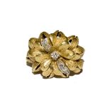 An 18 carat gold dress ring simulating flower heads with diamonds