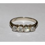 A four stone diamond ring set in 18 carat gold