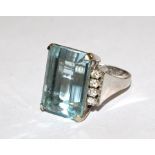 A large aquamarine with diamond shoulders set in 14 carat white gold