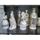 Seven Lladro figures, including two of a fishing boy, a Peruvian flute player and four figures of