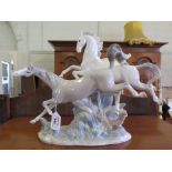 A Lladro figure of two prancing horses 30cm high