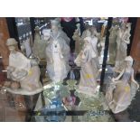 Two Lladro figures of shepherds, 27cm high, another of a seated wizard 30cm high, another of a