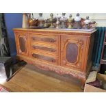 An early 20th century French oak and burrwood panelled sideboard, with raised back over three