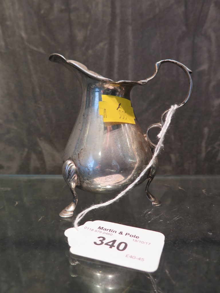 A Victorian silver cream jug on three hoof feet, marks rubbed