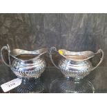 A silver cream jug with matching sugar bowl with fluted decoration, Birmingham 1975, 200 grams