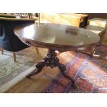 A rosewood oval centre table, parts Victorian, with turned stem and carved tripod base, 107cm wide