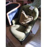 A late Victorian button back nursing chair, in dark green upholstery, on turned legs and castors