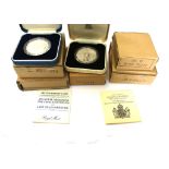 A collection of seven English commemorative coins boxed