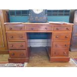 A late Victorian mahogany kneehole desk, the top with three frieze drawers over pedestals each