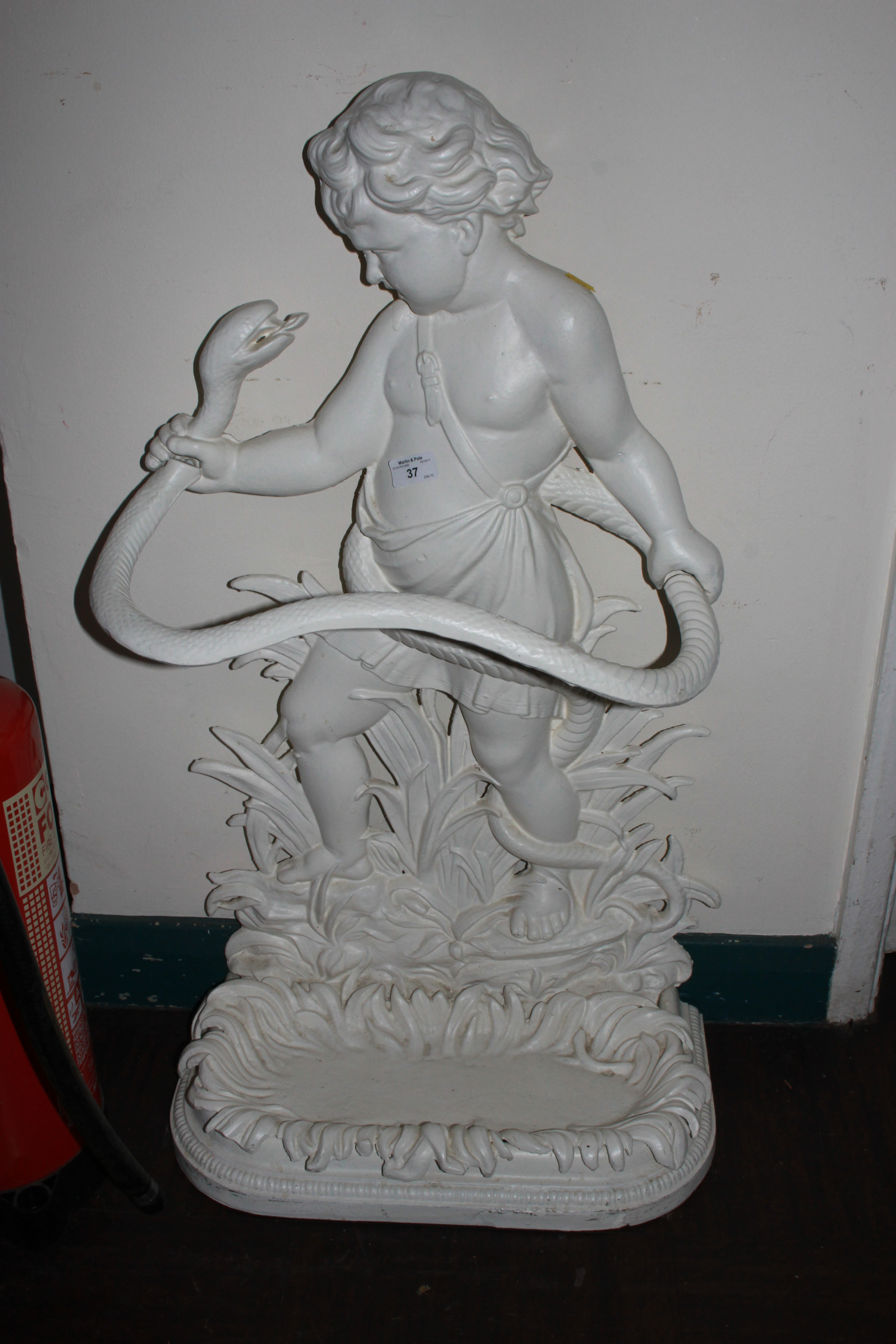 A painted cast iron umbrella stand in the form of a boy fighting a serpent, marked OWF, 80cm high