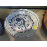 A pair of Chinese plates depicting clawed dragons in multiple borders, four character marks, 21cm