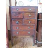 A George III mahogany cabinet, the hinged glass bijouterie top over a dummy drawer, four short and